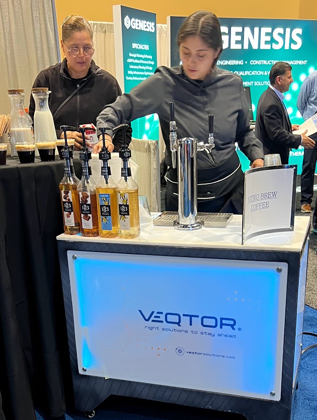 Barista serving espresso at a branded booth